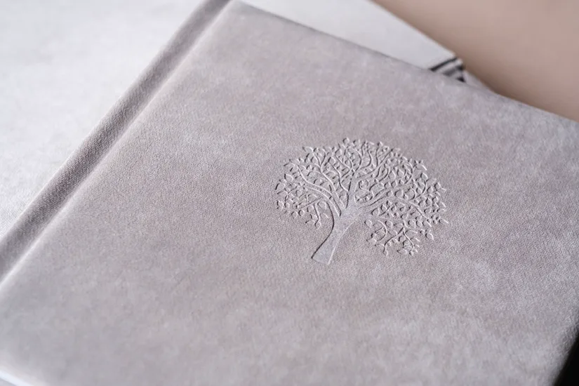 A debossed tree logo on a grey hardcover journal