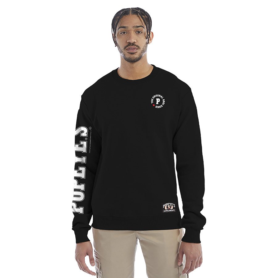 Black Popeye's Supplements crewneck on a model